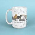 White mug with cat illustrations and text on a light blue background