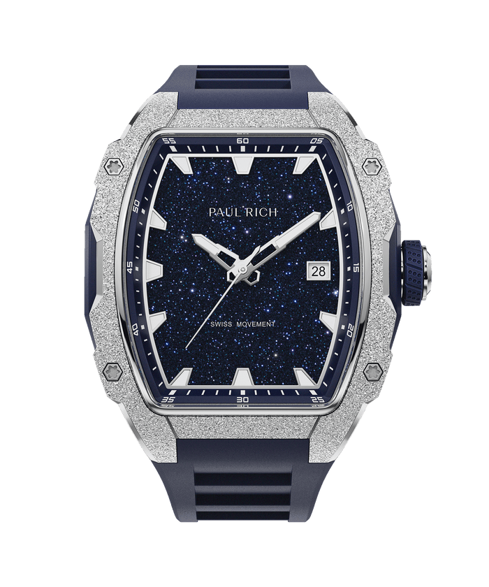 Paul Rich watch with frosted silver bezel, blue aventurine dial, date window, and blue rubber strap, in a tonneau-shaped case.