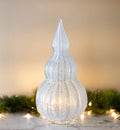 Grammy babushka tree white, with lights and garland in background.