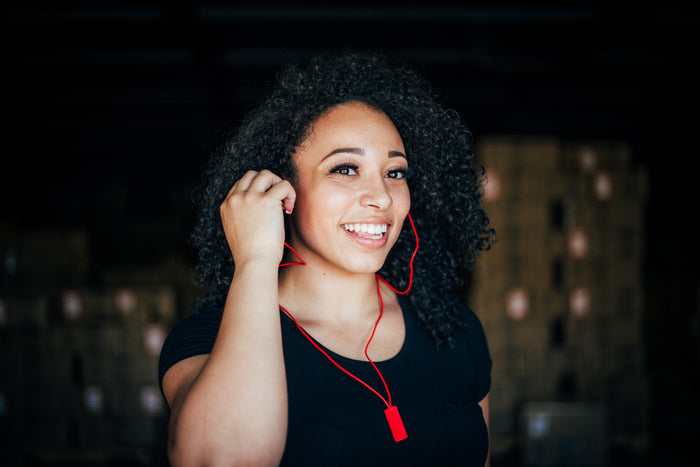 Red Bandido Earbud on smiling model.