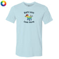 Light blue t-shirt with a colorful dog graphic and text 'Bark Less Love More' on a white background.