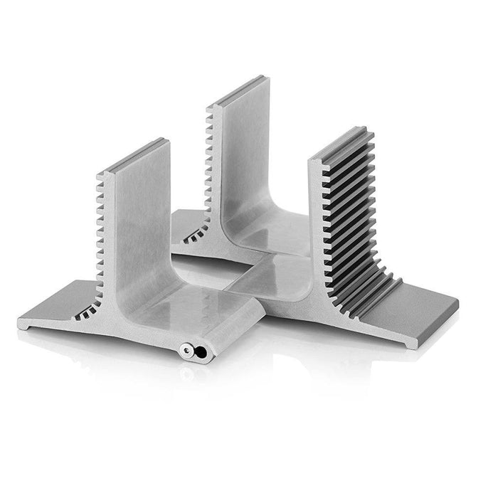Two machined metal components from the Burson Audio Cool Stand R (Large) by Burson Audio rest on a white background, showcasing their L-shaped profiles and ridged surfaces as precision-cut supports for this amplifier stand.