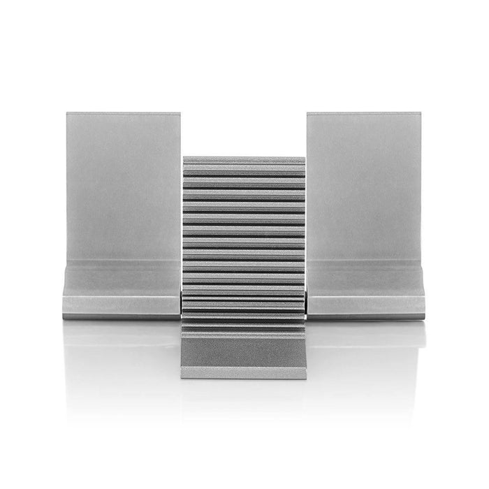 A sleek, silver Burson Audio Cool Stand R (Large) with a grooved adjustable center and flat side panels sits on a reflective white surface—perfect for displaying Burson Audio’s Class-A amplifiers. Now available on clearance.