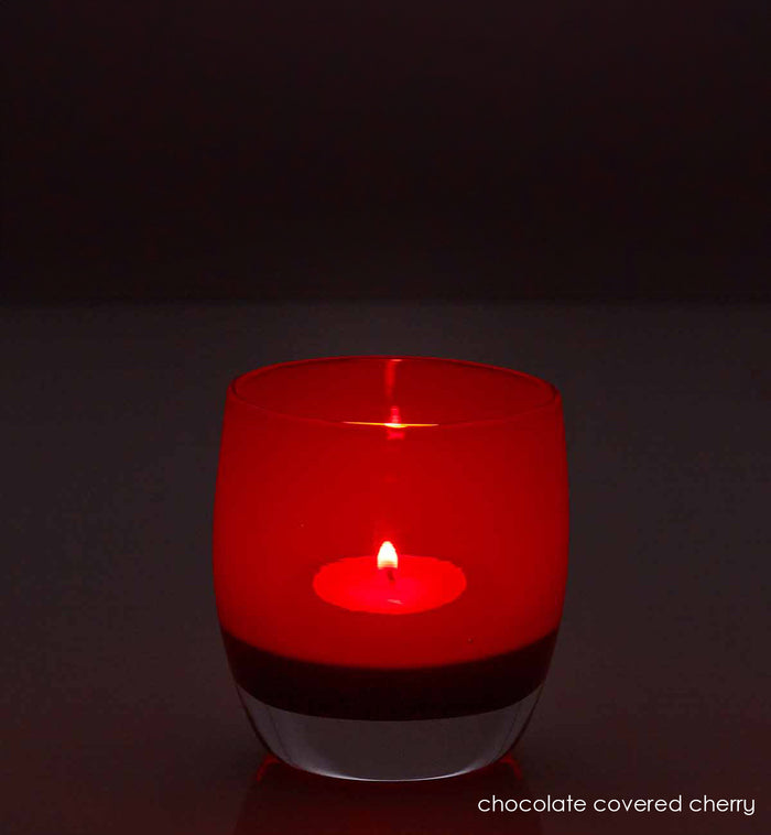 chocolate covered cherry, translucent red brown hand-blown glass votive candle holder. light by candle light.