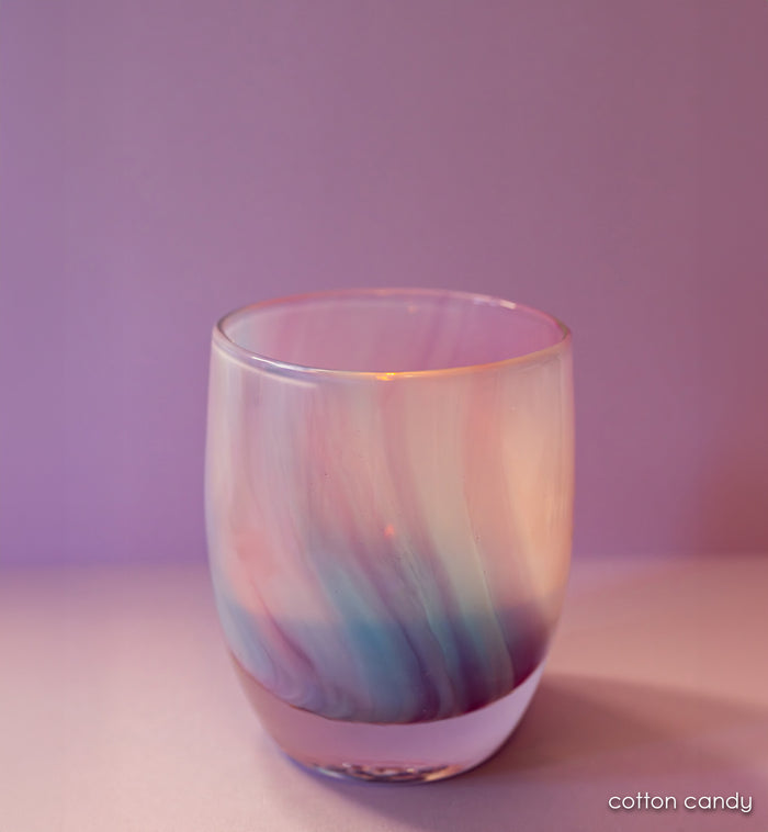 pink purple and blue hand-blown glass candle holder on a purple background