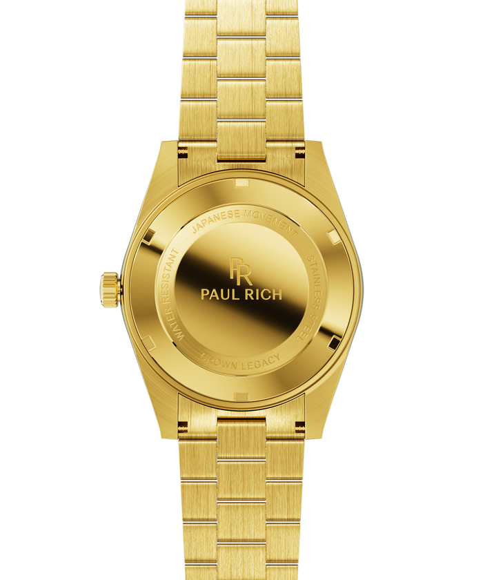 Gold watch case back with engraved text and logo, brushed gold bracelet links, and a matching gold crown.