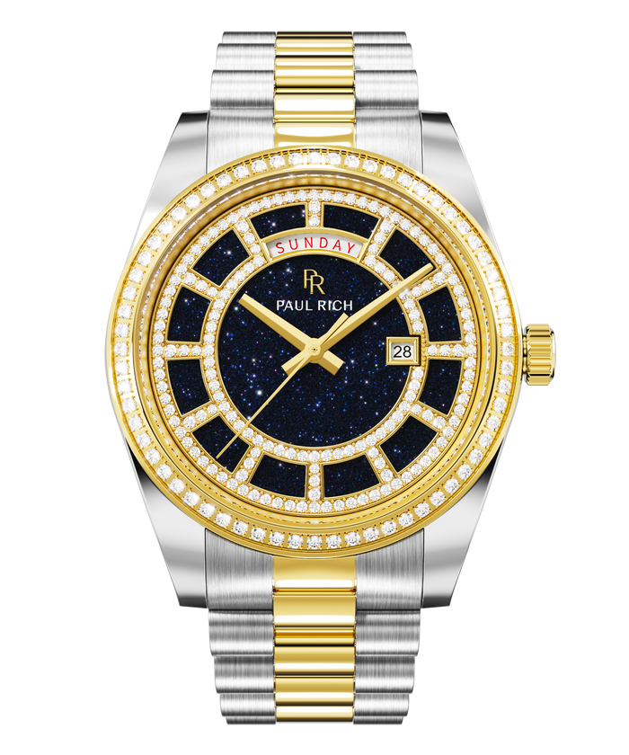 Two-tone silver and gold watch with a blue aventurine dial, day and date windows, and a bezel and hour markers set with clear stones.