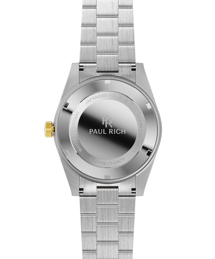 Stainless-steel watch case back with engraved text and logo, brushed bracelet links, and a gold crown.