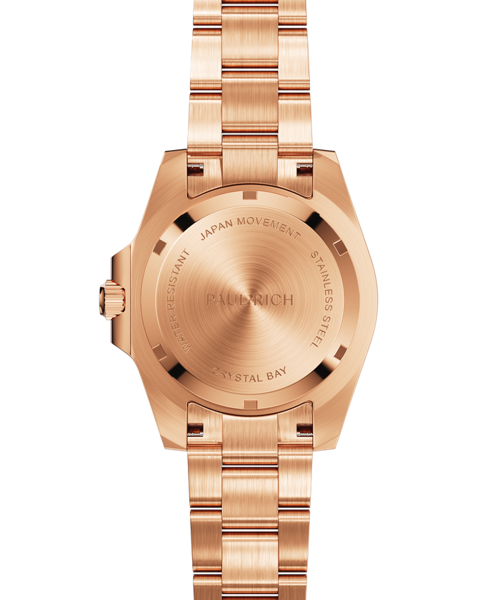 Rose-gold stainless steel watch case back and bracelet shown from the rear, highlighting engraved details and brushed metal texture.