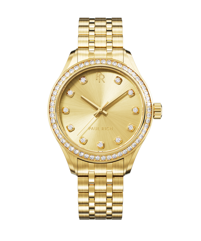 Front view of a gold-tone Paul Rich watch with a matching sunray dial, diamond hour markers, gem-set bezel, and gold jubilee bracelet.