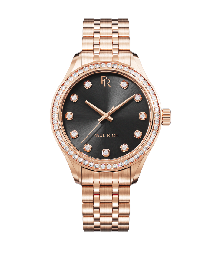 Front view of a rose gold Paul Rich watch with a black sunray dial, diamond hour markers, gem-set bezel, and rose gold jubilee bracelet.
