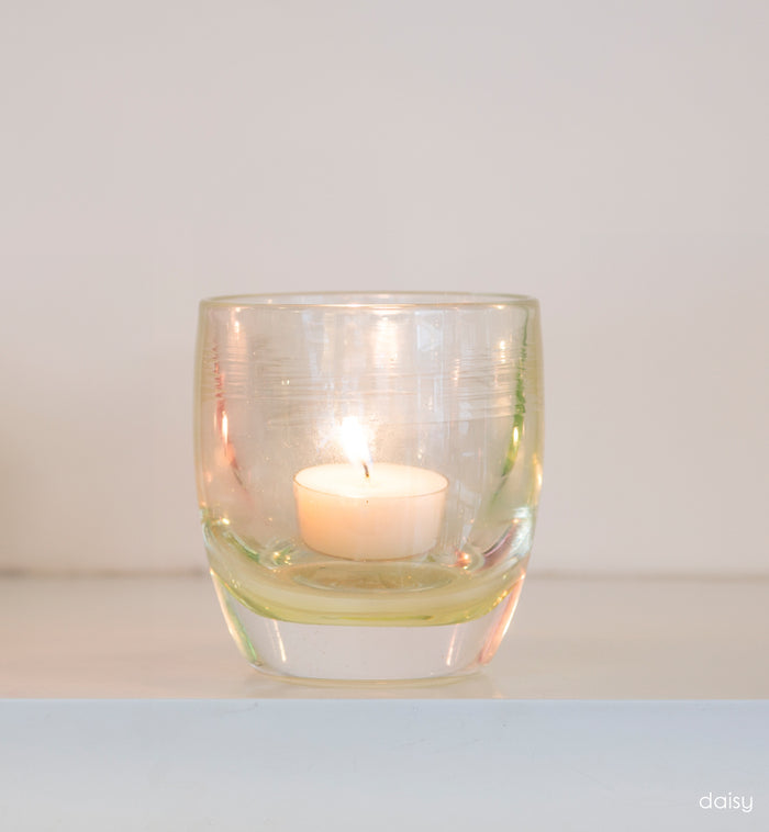 petunia transparent light pink hand-blown glass votive candle holder on white shelf