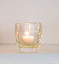 petunia transparent light pink hand-blown glass votive candle holder on white shelf