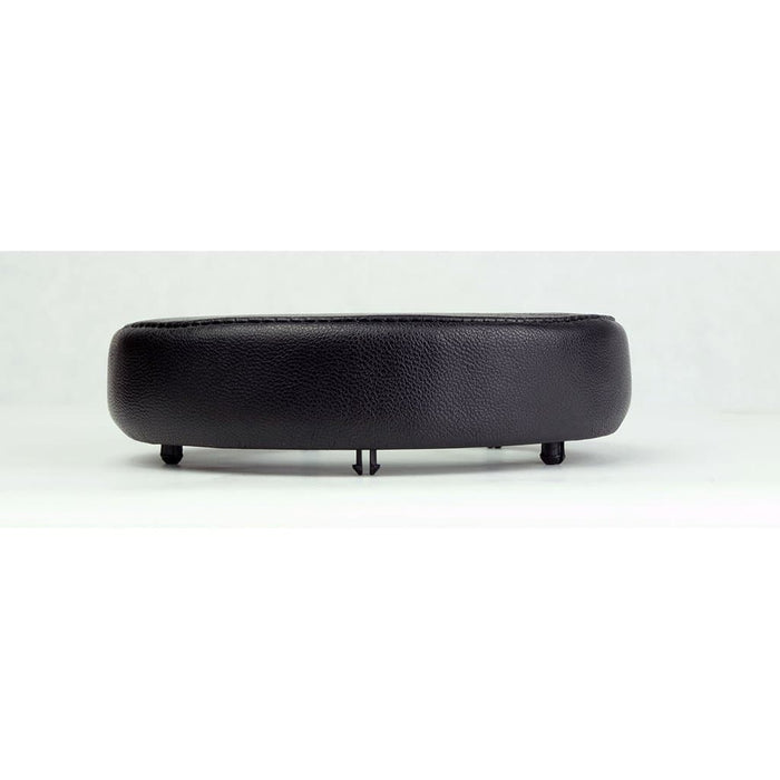 A black, round sheepskin replacement pad with short legs, viewed from the side on a white background—Dekoni Audio Elite Sheepskin Ear Pads for Focal headphones by Dekoni Audio.