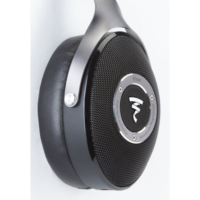 Close-up of black Focal headphones with a metallic frame and mesh grille, fitted with Dekoni Audio Elite Sheepskin Ear Pads. The brand logo is visible, and these premium pads from Dekoni Audio add comfort to your Focal headphones.