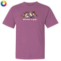 Purple t-shirt with cartoon dogs and 'different is good' text on a white background