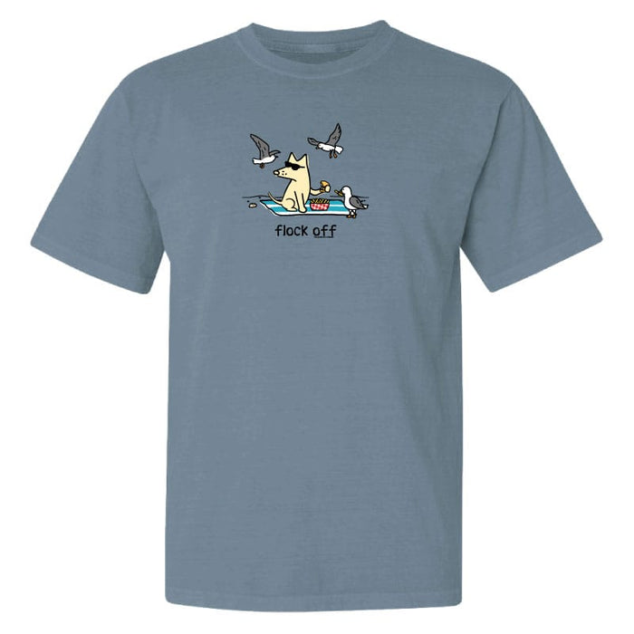 A heathered slate blue short-sleeve t-shirt with a cartoon graphic of a dog in a boat and three flying seagulls above, with the text 'flock off' printed below the graphic.
