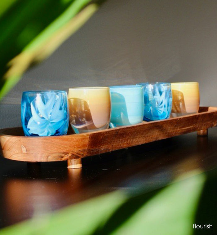 'flourish' is adorned with blue murrini flowers hand-crafted glass votive candle holders with tan and light blue  candle holders