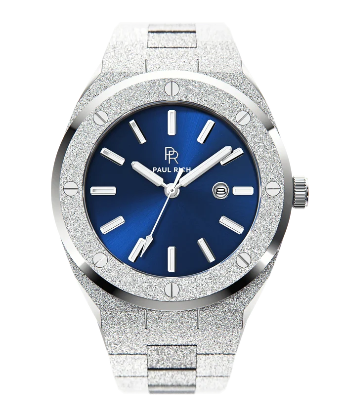 Front view of Paul Rich frosted silver watch with metallic blue sunray dial, silver markers, and date window, on transparent background.