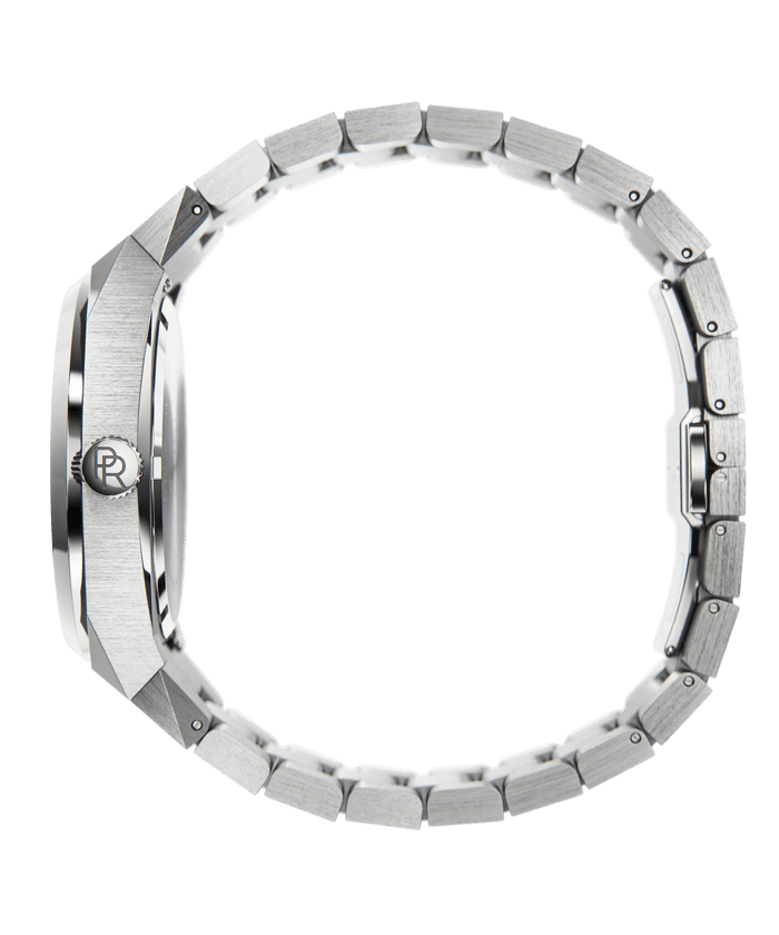 Side view of Paul Rich watch with round brushed silver case, PR monogram crown, and closed stainless steel bracelet, shown on transparent background.