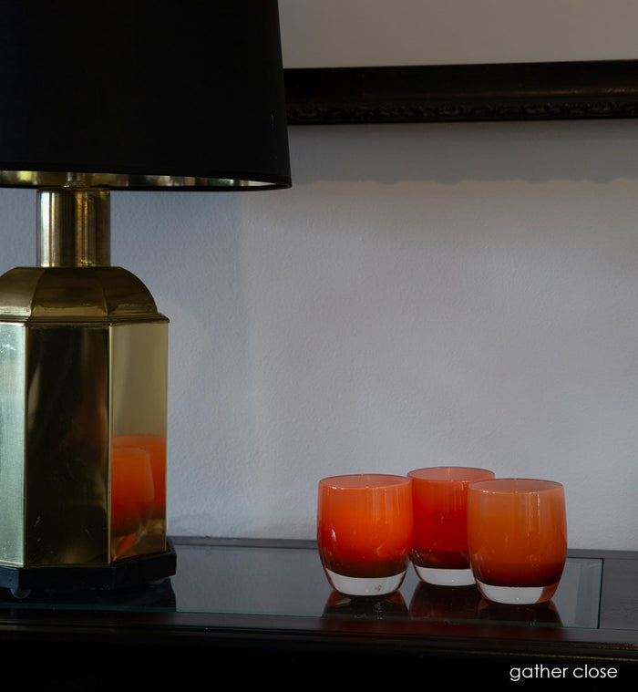 gather close, opaque amber, hand-blown glass votive candle holder.