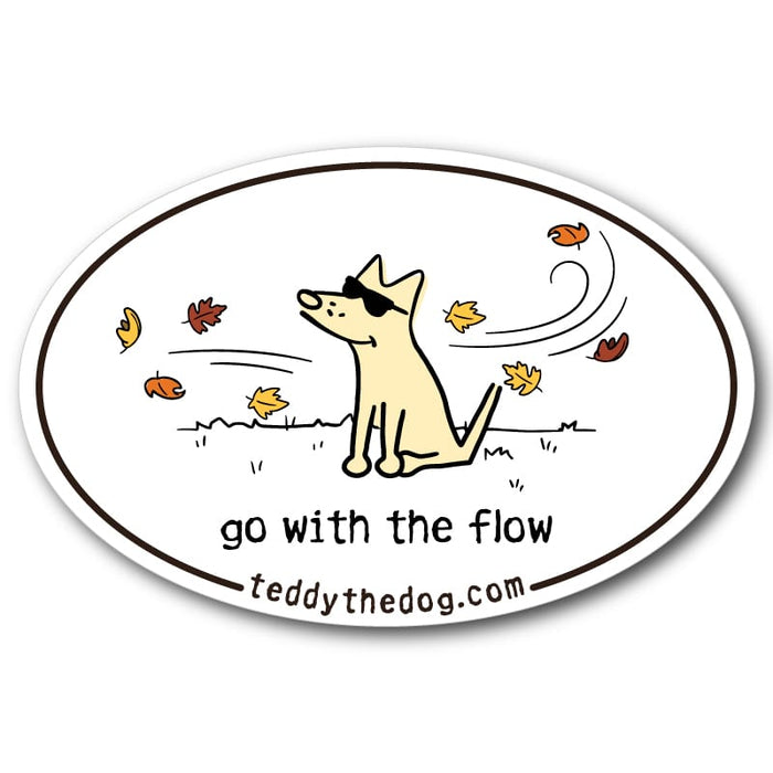 An oval sticker or decal featuring a cartoon dog wearing sunglasses with autumn leaves swirling around it. The text reads 'go with the flow' and 'teddythedog.