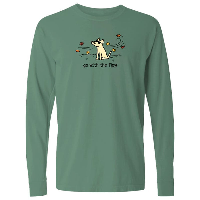 A sage green long-sleeve t-shirt with a cartoon graphic of a dog surrounded by flowers and the text 'go with the flow!' printed on the chest, displayed on a solid white background.