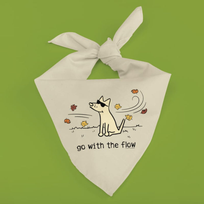 A white fabric dog bandana with a tied top, featuring a cartoon dog wearing sunglasses and the text 'go with the flow' on a bright green background.