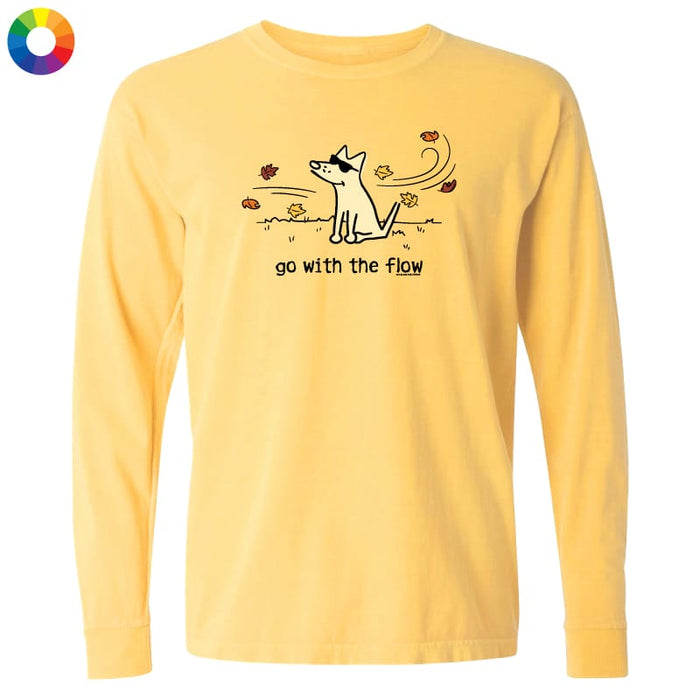 A pale yellow long-sleeve t-shirt with a graphic of a dog wearing sunglasses and the text 'go with the flow' printed on the chest, shown against a plain white background.