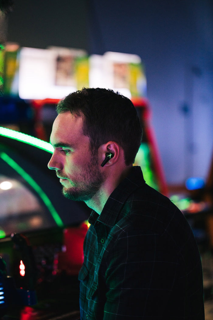 Grid Legion 200 Lifestyle image of man wearing earbud against neon lights
