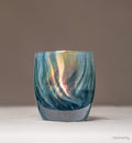 shimmering swirls of blue and green collide to create this ethereal hand-blown glass candle holder, heavenly.