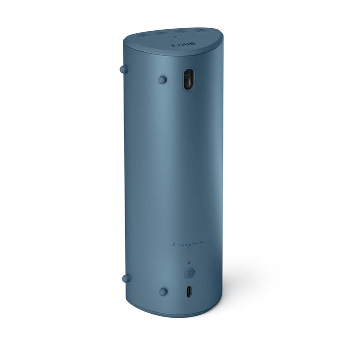 The KEF Muo HiFi Portable Bluetooth Speaker by KEF stands upright on a white background. It's tall, cylindrical, and blue, featuring minimal buttons, a small indicator light, and a USB-C port near the base on the front.