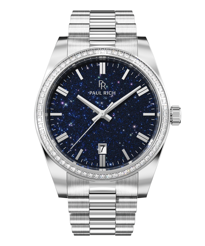 Silver watch with a blue aventurine dial, silver hour markers, date window at 6 o’clock, and crystal-set bezel.