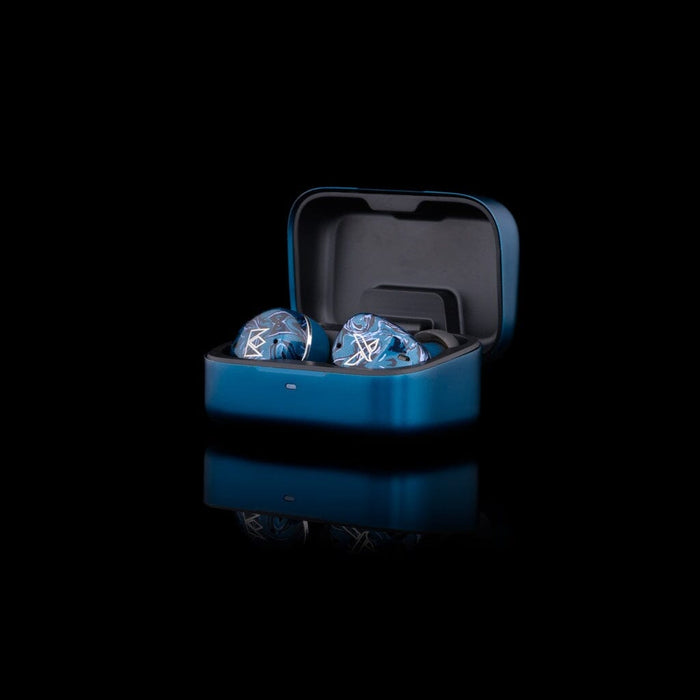 A pair of Noble Audio Osprey Wireless In-Ear Headphones with a blue marble pattern sit in an open blue charging case, shown against a black background with a soft reflection below.