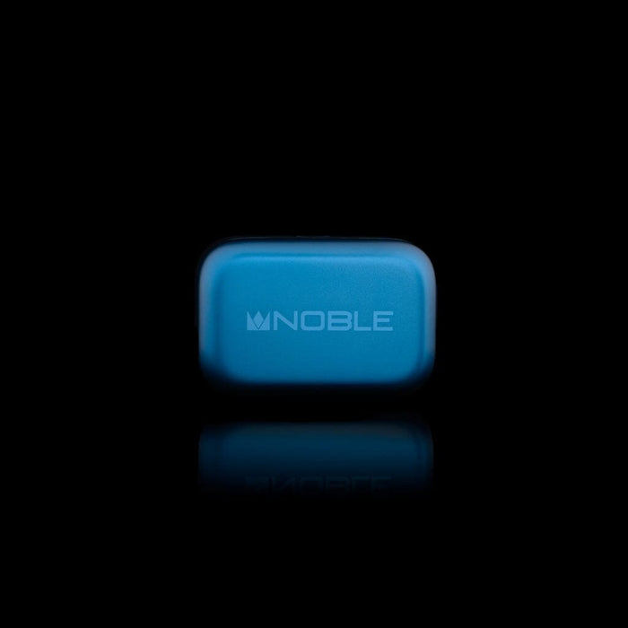 A blue rectangular case with "NOBLE" and a crown logo on the front, shown on a black background with a subtle reflection—ideal for storing your Noble Audio Osprey Wireless In-Ear Headphones.