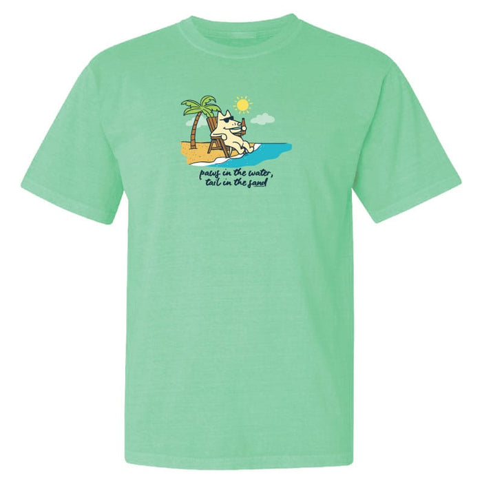 Light green t-shirt with a graphic of a dog on a beach and text 'surf in the water, tail in the sand' on a white background.