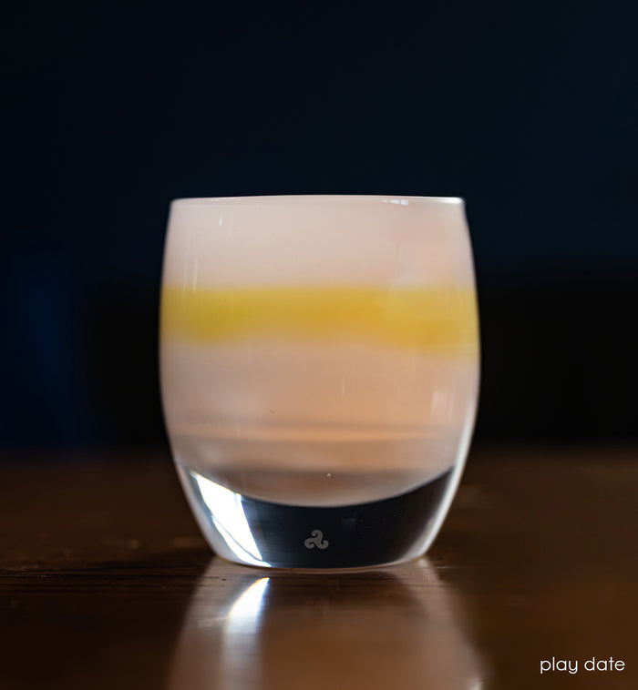 light blue and yellow chartreuse  hand-crafted glass votive candle holder lit with dark blue background