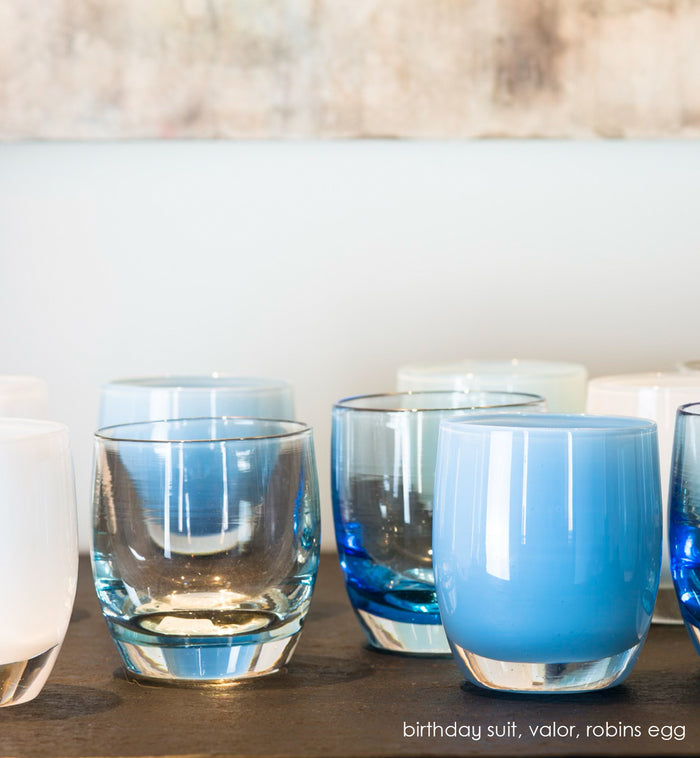 robins egg blue, hand-blown glass votive candle holder. paired with birthday suit transparent glass, and valor blue transparent.