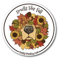 A round sticker or decal with a white border and the text 'smells like fall' at the top and 'teddythedog.com' at the bottom.