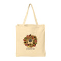 A natural beige canvas tote bag with two shoulder straps, featuring a central graphic of a dog's face framed by a colorful autumn wreath of sunflowers and leaves, with the text 'smells like fall' printed below.