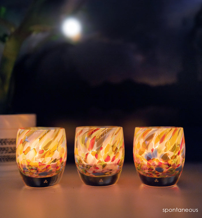 ‘spontaneous’ glassybaby - a multicolor hand-blown glass candle holder at night