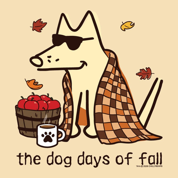 A stylized fall-themed illustration of a cream-colored dog wearing black sunglasses, wrapped in an orange and brown plaid blanket, sitting beside a basket of red apples and a white mug with a black paw print. The text 'the dog days of fall' appears at the bottom on a warm beige background with scattered autumn leaves.