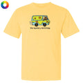 Yellow t-shirt featuring a graphic of a green and yellow van resembling the Mystery Machine with a brown dog driving and the text "the mystery muttchine" below.