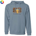 A dusty blue-gray pullover hoodie with a front kangaroo pocket and drawstring hood, featuring a central graphic of a yellow dog sitting in a field framed by autumn trees, with the text 'The dogs they love are everyone'. A small multicolor color wheel icon is in the top-left corner on a white background.
