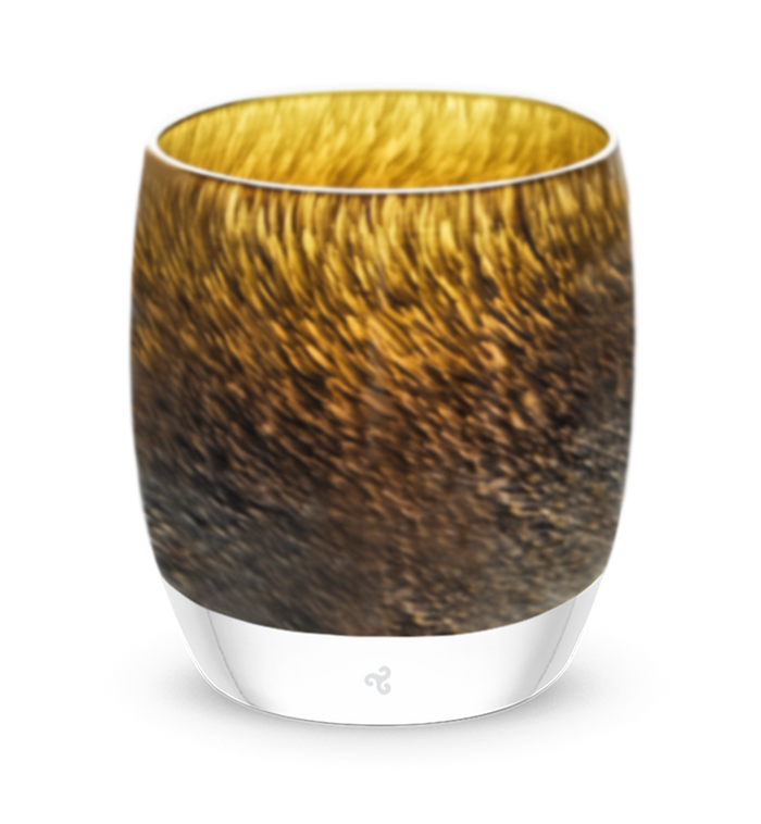 under a wing, an amber and brown mottled hand-blown glass votive candle holder.