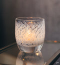 yes, white unique bubble pattern hand-blown glass votive candle holders on glass table.